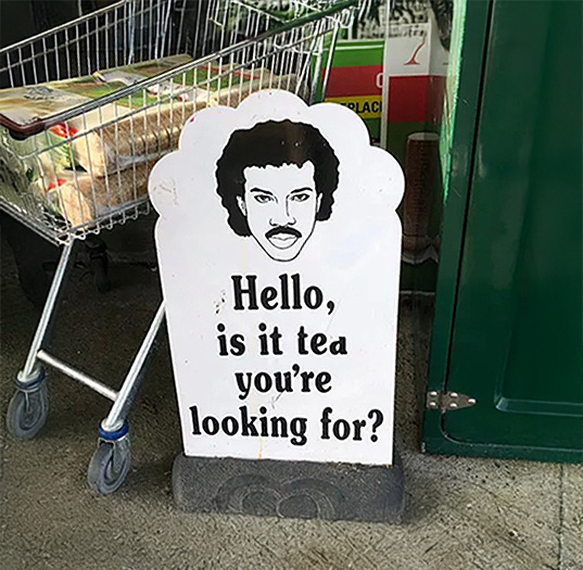 Sign outside a shop that reads 'Hello is it tea you're looking for'.