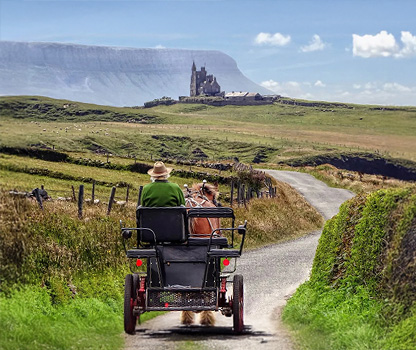 Pony trap in foreground traveling along country road with castle in background