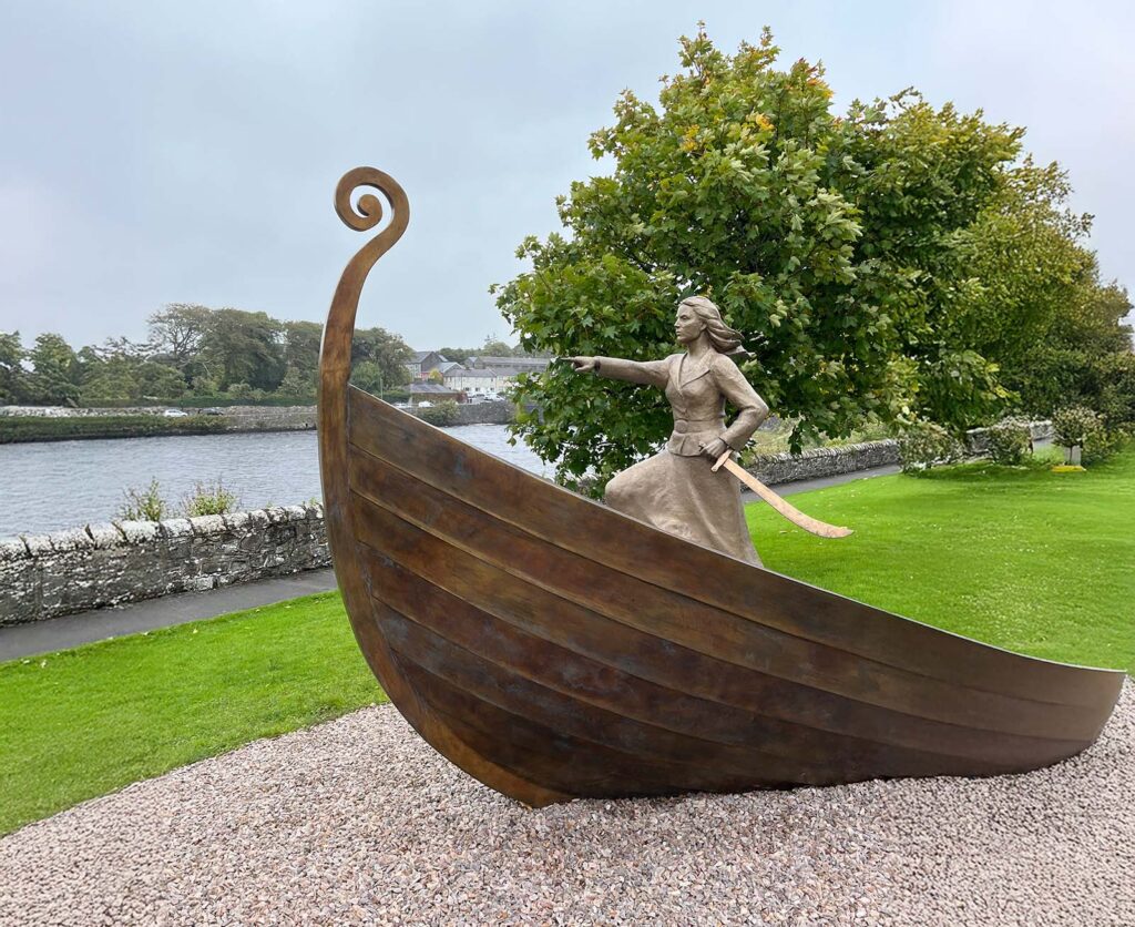 The Pirate Queen - sculpture of woman in a viking boat with drawn sword