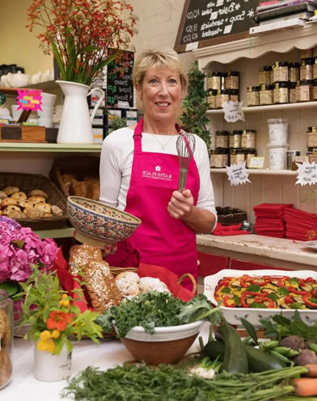 Woman holding a whisk in a shop